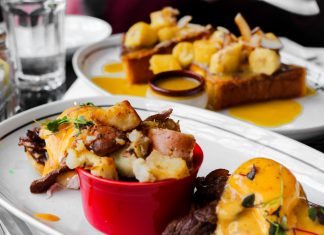 Close-up of delicious eggs benedict and banana topping toast served in Montreal cafe.