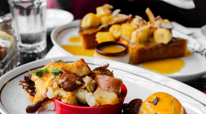 Close-up of delicious eggs benedict and banana topping toast served in Montreal cafe.
