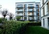 BREAKING: 132-Unit Ridge Pointe Complex Sold in Fort Lee Contemporary apartment complex with balconies and lush garden in urban setting.