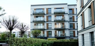 BREAKING: 132-Unit Ridge Pointe Complex Sold in Fort Lee Contemporary apartment complex with balconies and lush garden in urban setting.