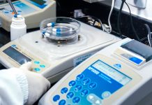 BREAKING: $300K Pharma Job Leads 8 New Jersey Openings Close-up of laboratory equipment with capsules, capturing pharmaceutical analysis.