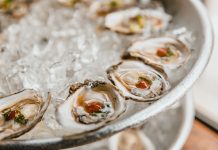 BREAKING: Bembe Steak & Raw Bar Soft Opens on Newark Avenue Close-up of fresh oysters served on a bed of crushed ice, perfect for seafood lovers.