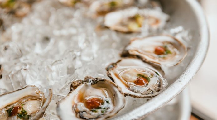 Close-up of fresh oysters served on a bed of crushed ice, perfect for seafood lovers.