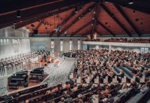 BREAKING: Bingo Night Set to Boost St. Aloysius Restoration Fund A large congregation attending a conference in a modern church setting.