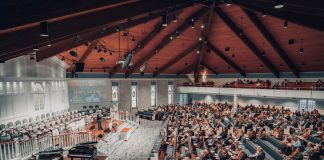 BREAKING: Bingo Night Set to Boost St. Aloysius Restoration Fund A large congregation attending a conference in a modern church setting.