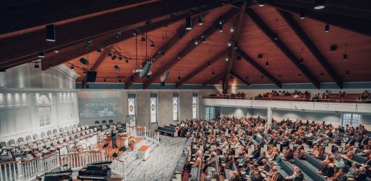 BREAKING: Bingo Night Set to Boost St. Aloysius Restoration Fund A large congregation attending a conference in a modern church setting.