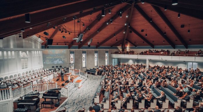 A large congregation attending a conference in a modern church setting.