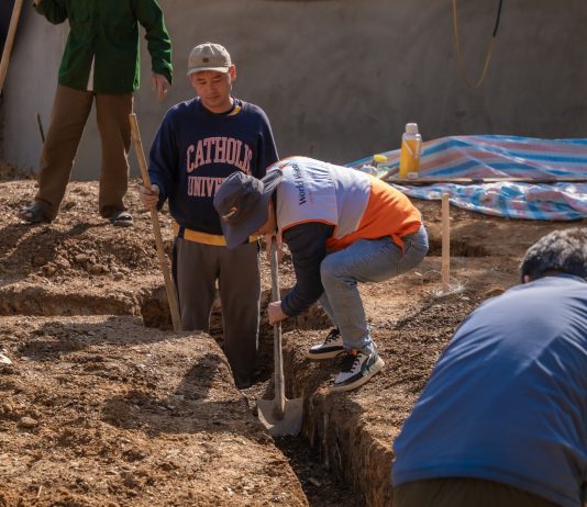 BREAKING: Construction Begins on New Bayonne Food Pantry Volunteers working together to dig a trench at a construction site in daylight.