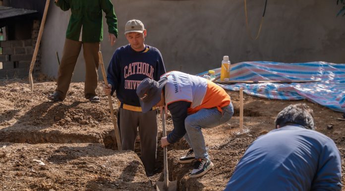 BREAKING: Construction Begins on New Bayonne Food Pantry Volunteers working together to dig a trench at a construction site in daylight.