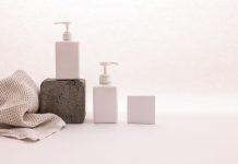 BREAKING: Ethos Aesthetics Launches New September ‘Back to You’ Bundle in Hoboken Stylish minimalist setup with cosmetic pump bottles and fabric on a white background, ideal for beauty product presentation.