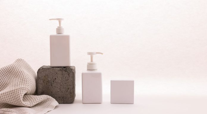 BREAKING: Ethos Aesthetics Launches New September ‘Back to You’ Bundle in Hoboken Stylish minimalist setup with cosmetic pump bottles and fabric on a white background, ideal for beauty product presentation.