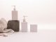 BREAKING: Ethos Aesthetics Launches New September ‘Back to You’ Bundle in Hoboken Stylish minimalist setup with cosmetic pump bottles and fabric on a white background, ideal for beauty product presentation.