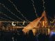 BREAKING: Fall 2026 Festival Guide for Hoboken, Jersey City A vibrant evening market scene under string lights with people gathering in a lively atmosphere.