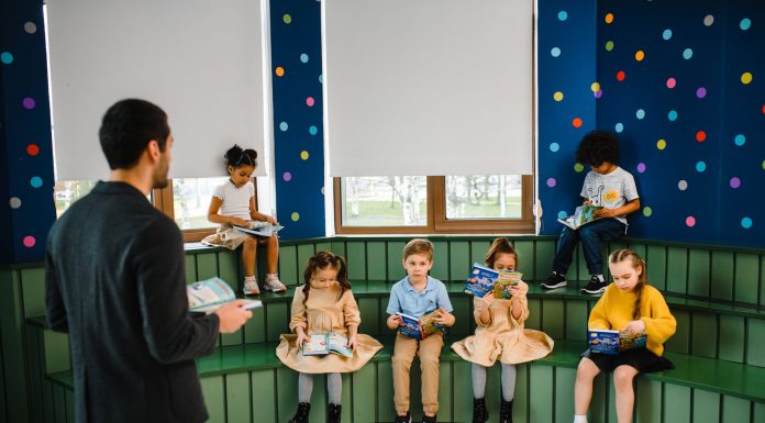 BREAKING: Former Teacher Reads Newark Kids to Brighter Futures Preschool teacher leading storytime with children reading books in a colorful classroom setting.