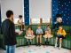 BREAKING: Former Teacher Reads Newark Kids to Brighter Futures Preschool teacher leading storytime with children reading books in a colorful classroom setting.