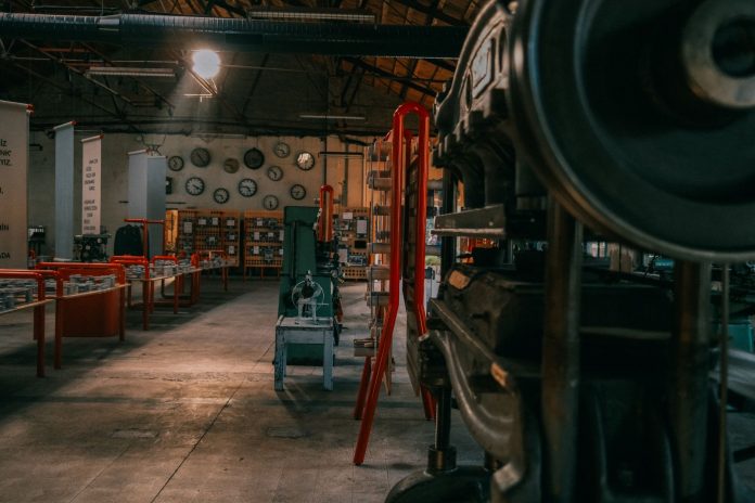 A rustic industrial workshop filled with vintage machinery and tools.