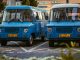 BREAKING: Jersey City Library Announces Bookmobile Hours at Five Corners Two retro blue vans parked side by side in a city environment, showcasing classic design.