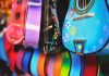 Vibrant close-up of artistically decorated acoustic guitars with floral patterns.
