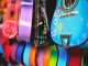 Vibrant close-up of artistically decorated acoustic guitars with floral patterns.