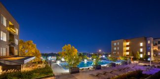 Night view of a luxurious apartment complex with a swimming pool in Westminster, Colorado, USA.