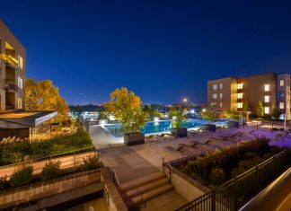 Night view of a luxurious apartment complex with a swimming pool in Westminster, Colorado, USA.