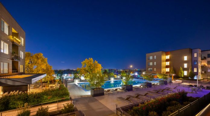 Night view of a luxurious apartment complex with a swimming pool in Westminster, Colorado, USA.