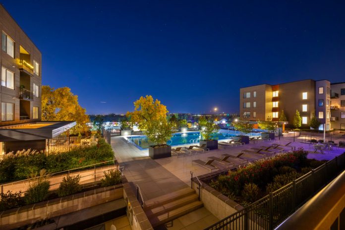 Night view of a luxurious apartment complex with a swimming pool in Westminster, Colorado, USA.