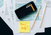 BREAKING: New Tool Helps NJ Families Claim $1,000 Child Tax Credit Top view of financial papers with a calculator, pencils, and a note saying 'Need help?' indicating tax or accounting assistance.