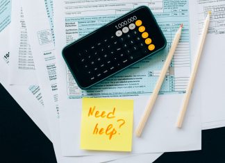 BREAKING: New Tool Helps NJ Families Claim $1,000 Child Tax Credit Top view of financial papers with a calculator, pencils, and a note saying 'Need help?' indicating tax or accounting assistance.