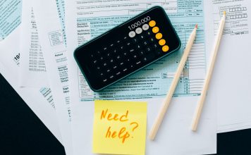 BREAKING: New Tool Helps NJ Families Claim $1,000 Child Tax Credit Top view of financial papers with a calculator, pencils, and a note saying 'Need help?' indicating tax or accounting assistance.