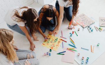 BREAKING: Newark Community Art Project ‘The Golden Life’ Debuts in Documentary Group of women designing artistic placards with colorful materials.