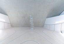 A minimalist and futuristic interior featuring stacked stones and white walls.