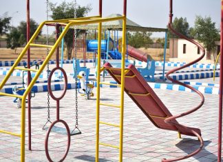 Vibrant playground with slides and swings in outdoor park setting.