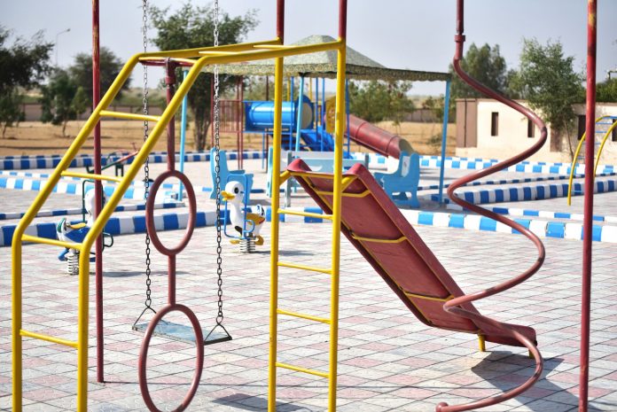 breaking-virginia-avenue-park-reopens-with-new-pla Vibrant playground with slides and swings in outdoor park setting.