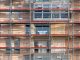 Scaffolding covers an urban building facade, capturing a construction site in detail.