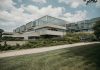 Contemporary glass and concrete university building with lush greenery in Chicago, USA.