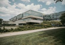 Contemporary glass and concrete university building with lush greenery in Chicago, USA.