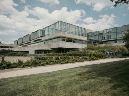 Contemporary glass and concrete university building with lush greenery in Chicago, USA.