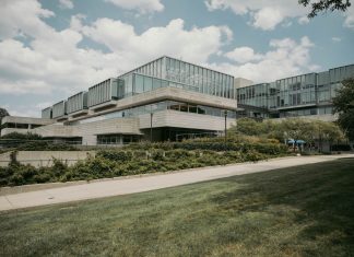 Contemporary glass and concrete university building with lush greenery in Chicago, USA.