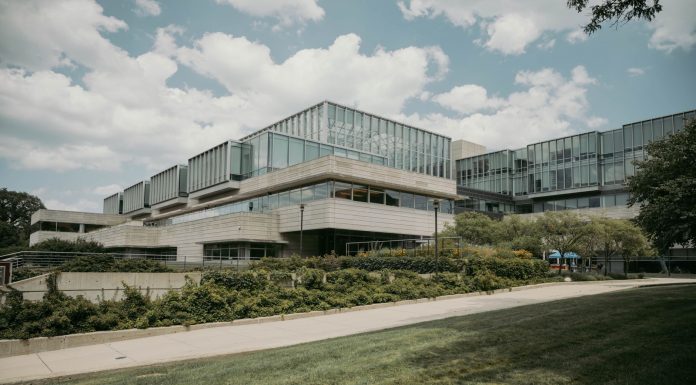 Contemporary glass and concrete university building with lush greenery in Chicago, USA.