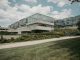 Contemporary glass and concrete university building with lush greenery in Chicago, USA.