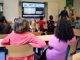 Students attentively watching a lesson on a smart board in a colorful Dutch classroom.