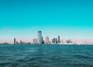 Panoramic view of Manhattan skyline with modern skyscrapers under a clear blue sky.