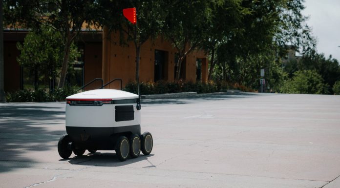 Delivery Robots Rolling Into Hoboken This September A sleek autonomous food delivery robot navigates a sunny urban landscape, showcasing modern innovation.
