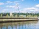Free Things to Do in Bayonne: 12 Budget-Friendly Local Favorites (2026 Guide) Tranquil water reflection and wooden pier under a vibrant blue sky in Alpine, New Jersey.