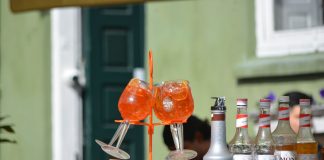Colorful Aperol Spritz and Monin syrups on display outdoors, perfect for summer cocktails.