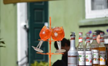 Halifax in Hoboken Serves Aperol Spritz Trees for Summer Send-Off Colorful Aperol Spritz and Monin syrups on display outdoors, perfect for summer cocktails.