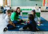 How to Enroll Your Child in Bayonne Public Schools: A 2026 Guide for Hudson County Families Teacher and children engaged in educational activities on a classroom floor.