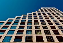 A modern high-rise building in Eindhoven, Netherlands with a clear blue sky backdrop.