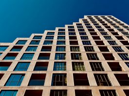 A modern high-rise building in Eindhoven, Netherlands with a clear blue sky backdrop.